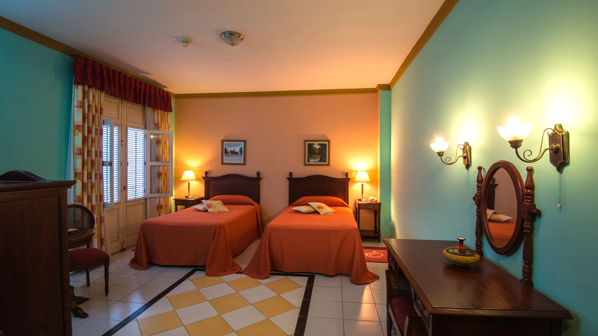 a room with two beds and a mirror