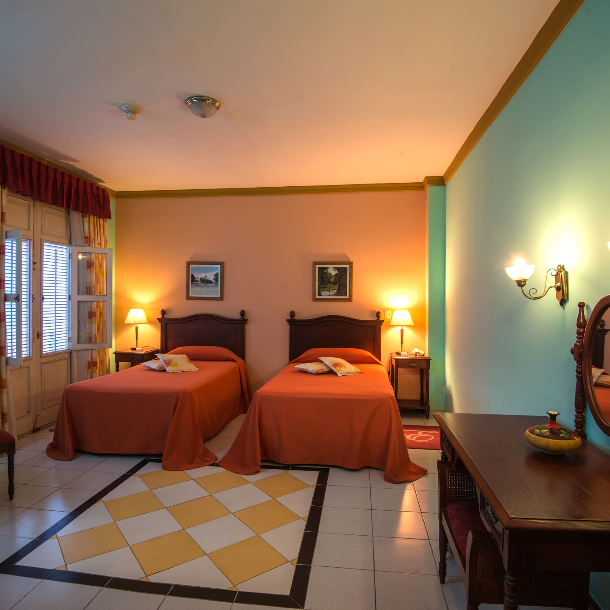 a room with two beds and a mirror