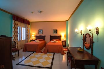 a room with two beds and a mirror