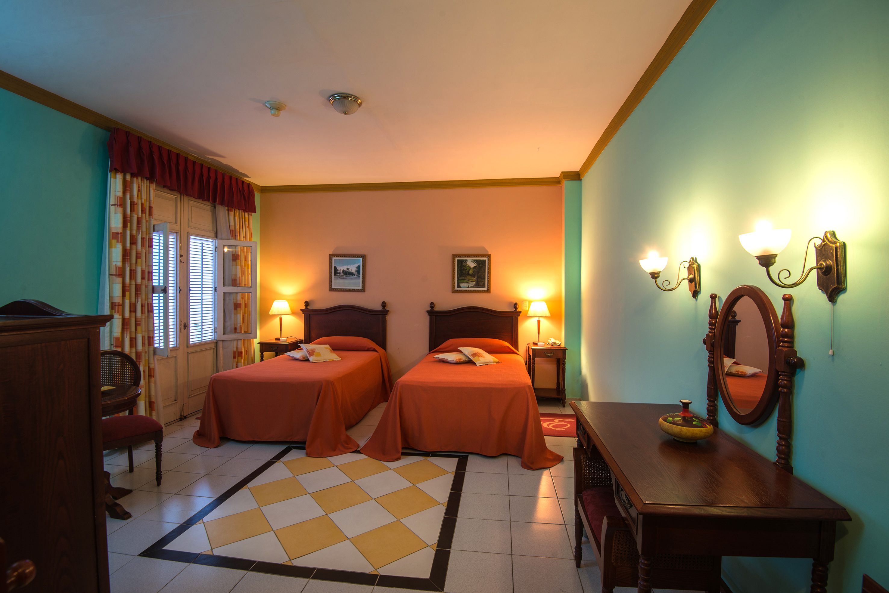 a room with two beds and a mirror