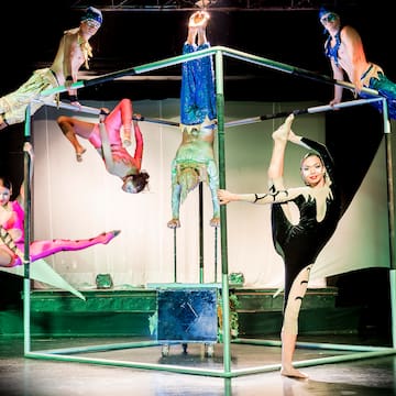 a group of people performing acrobats on a stage