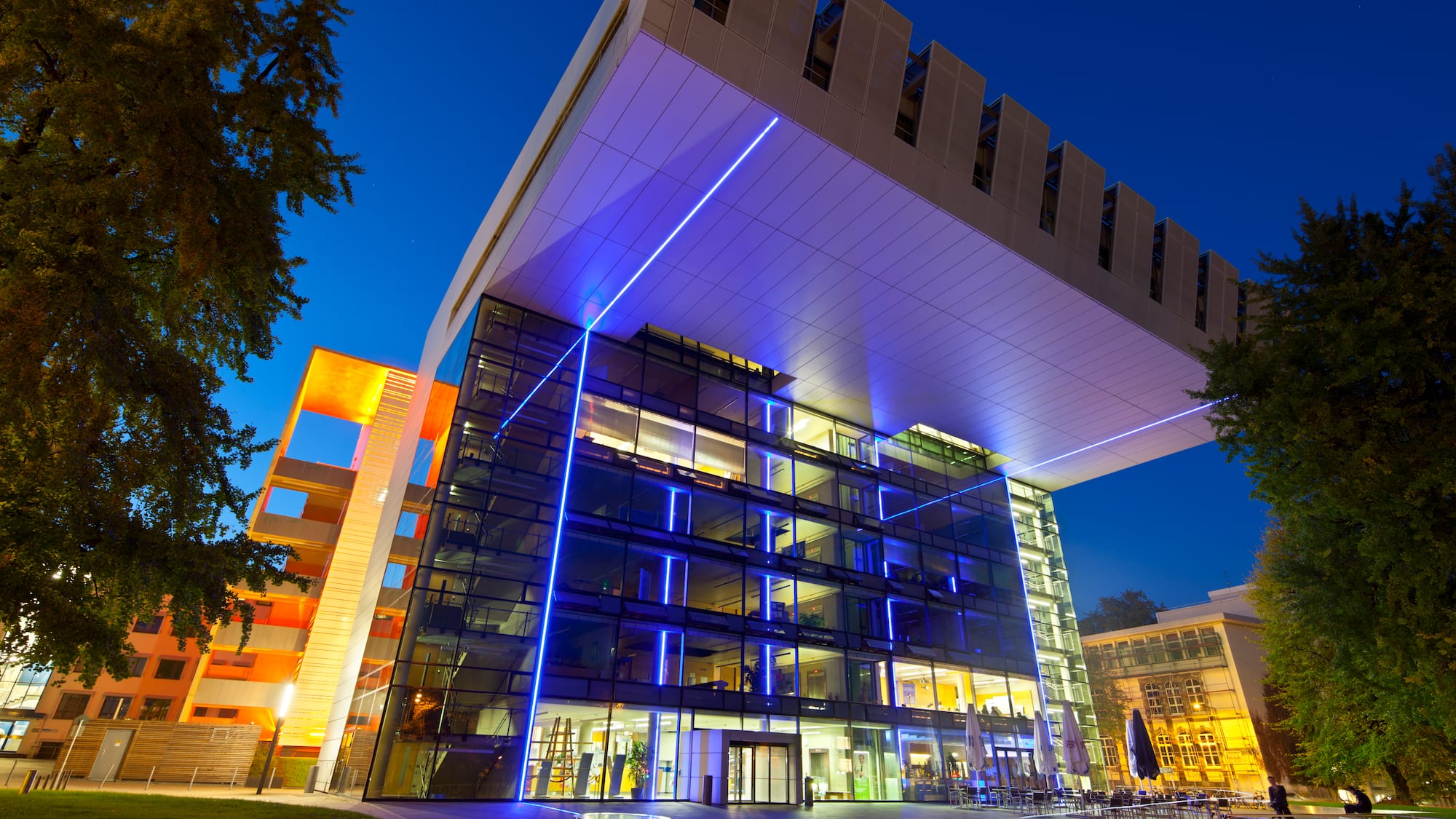a building with many windows and blue lights