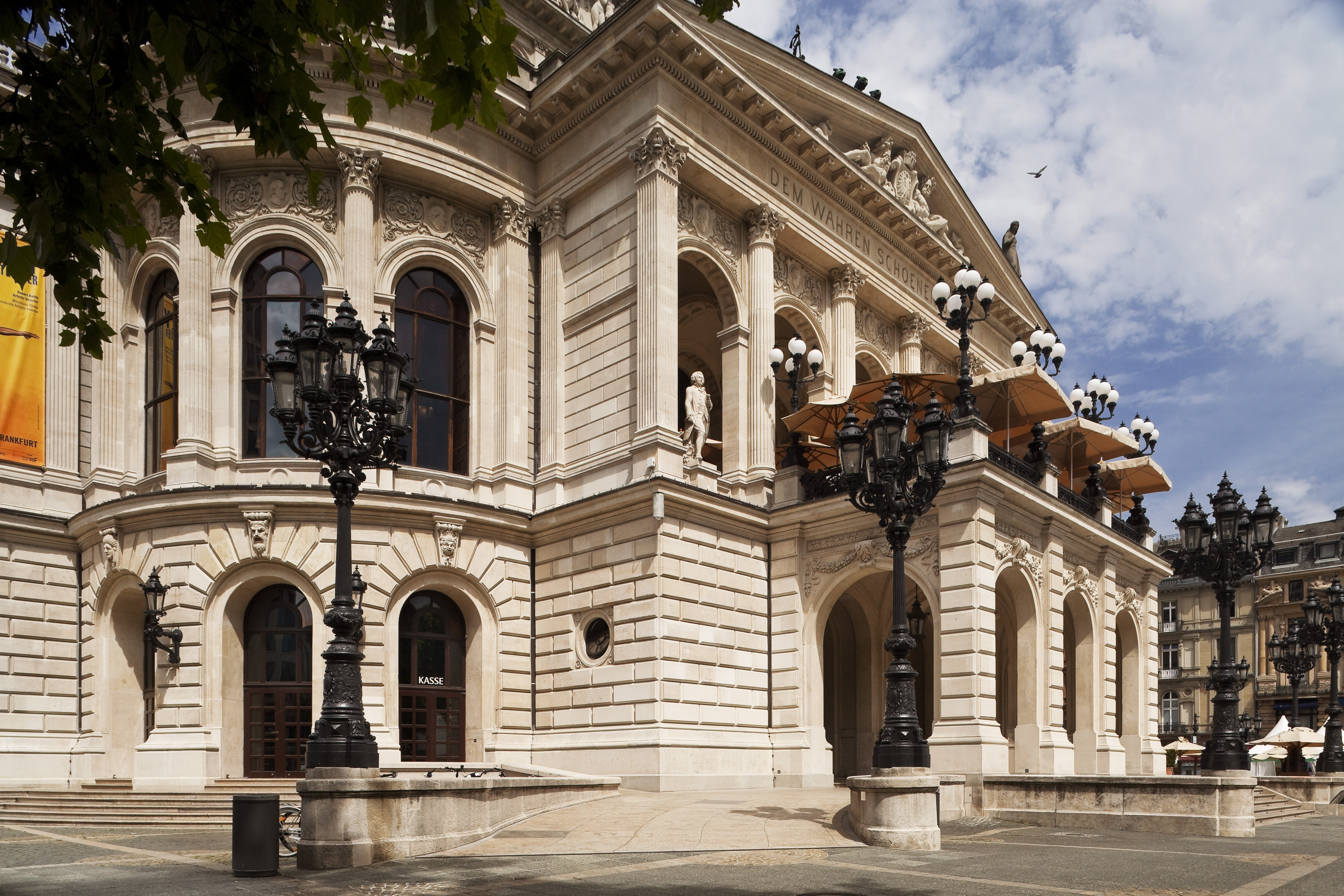 a building with columns and a stone wall