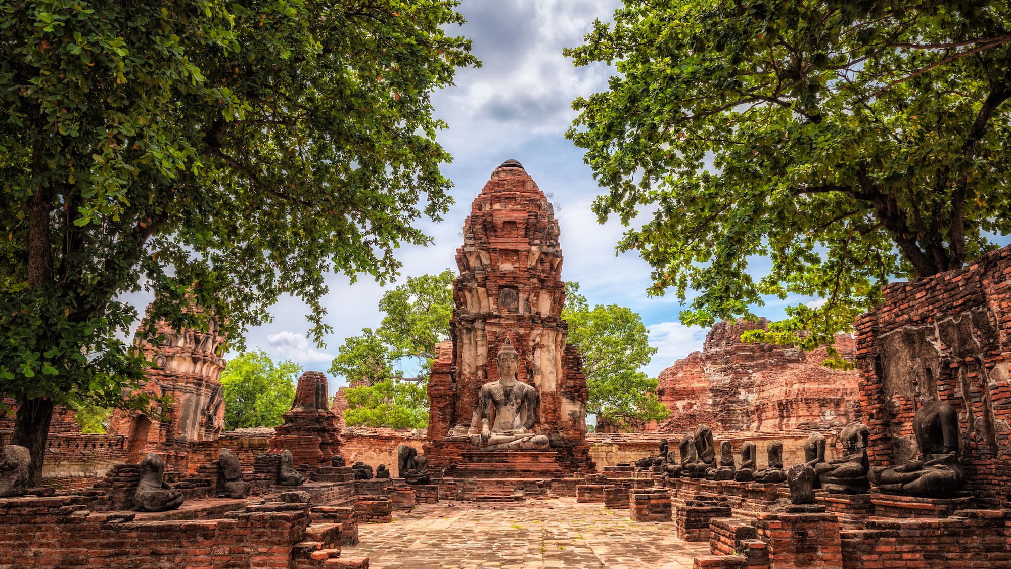 a stone structure with a statue in the middle of it