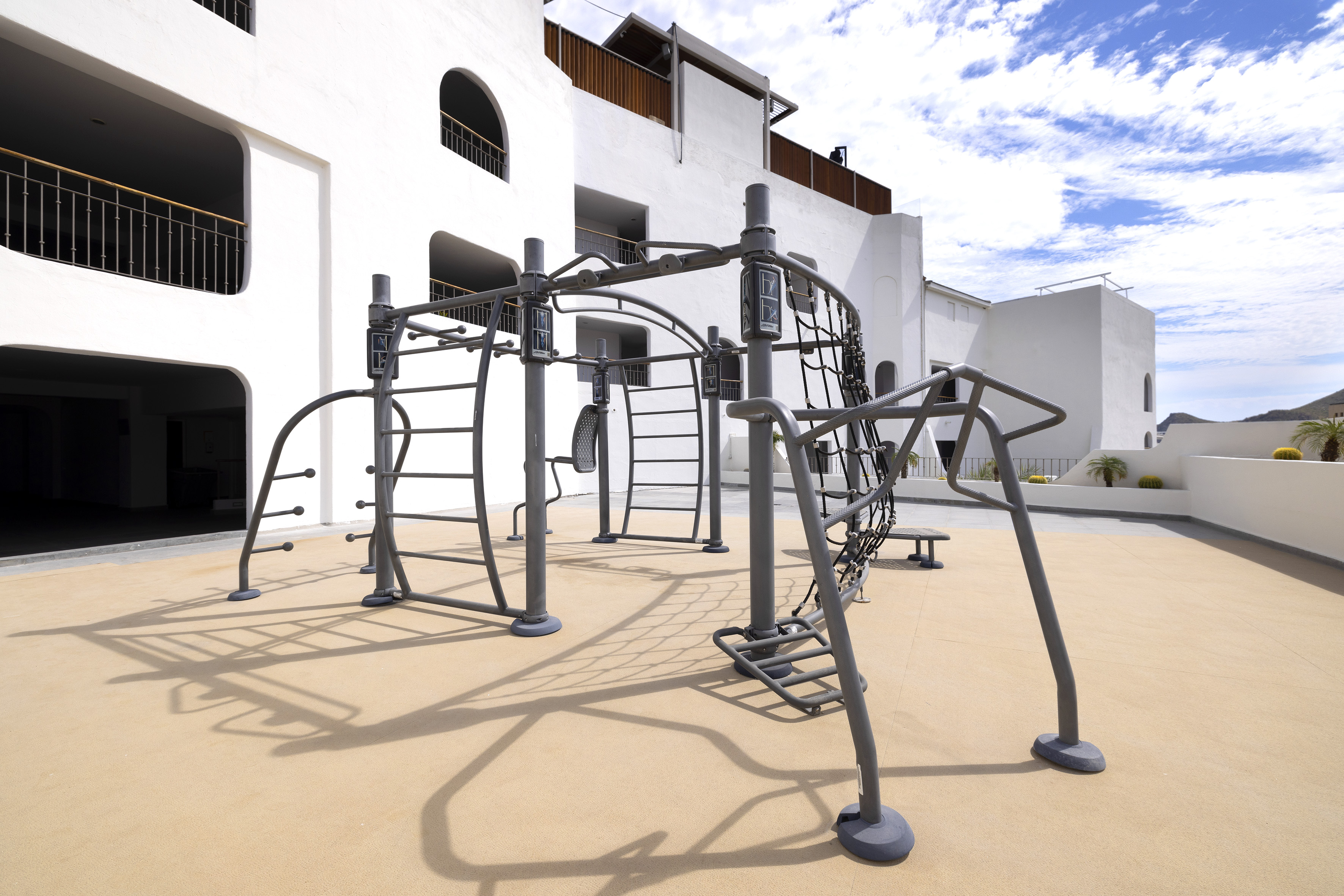 a playground with a white building in the background