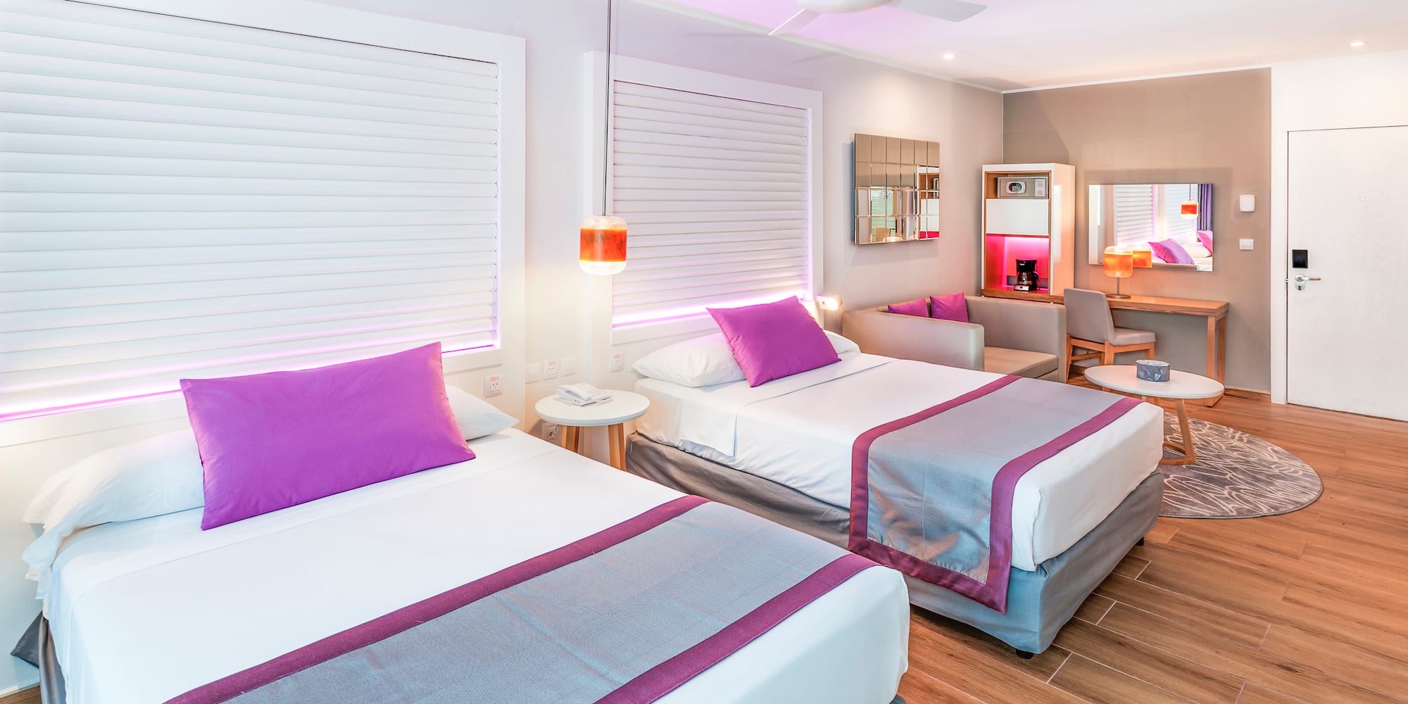 a room with two beds and a ceiling fan