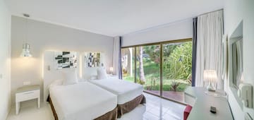 a room with two beds and a glass door