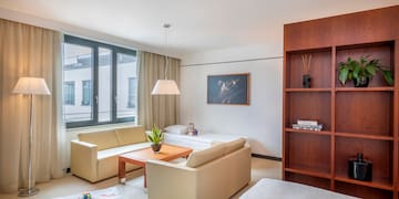 a living room with couches and a bookcase