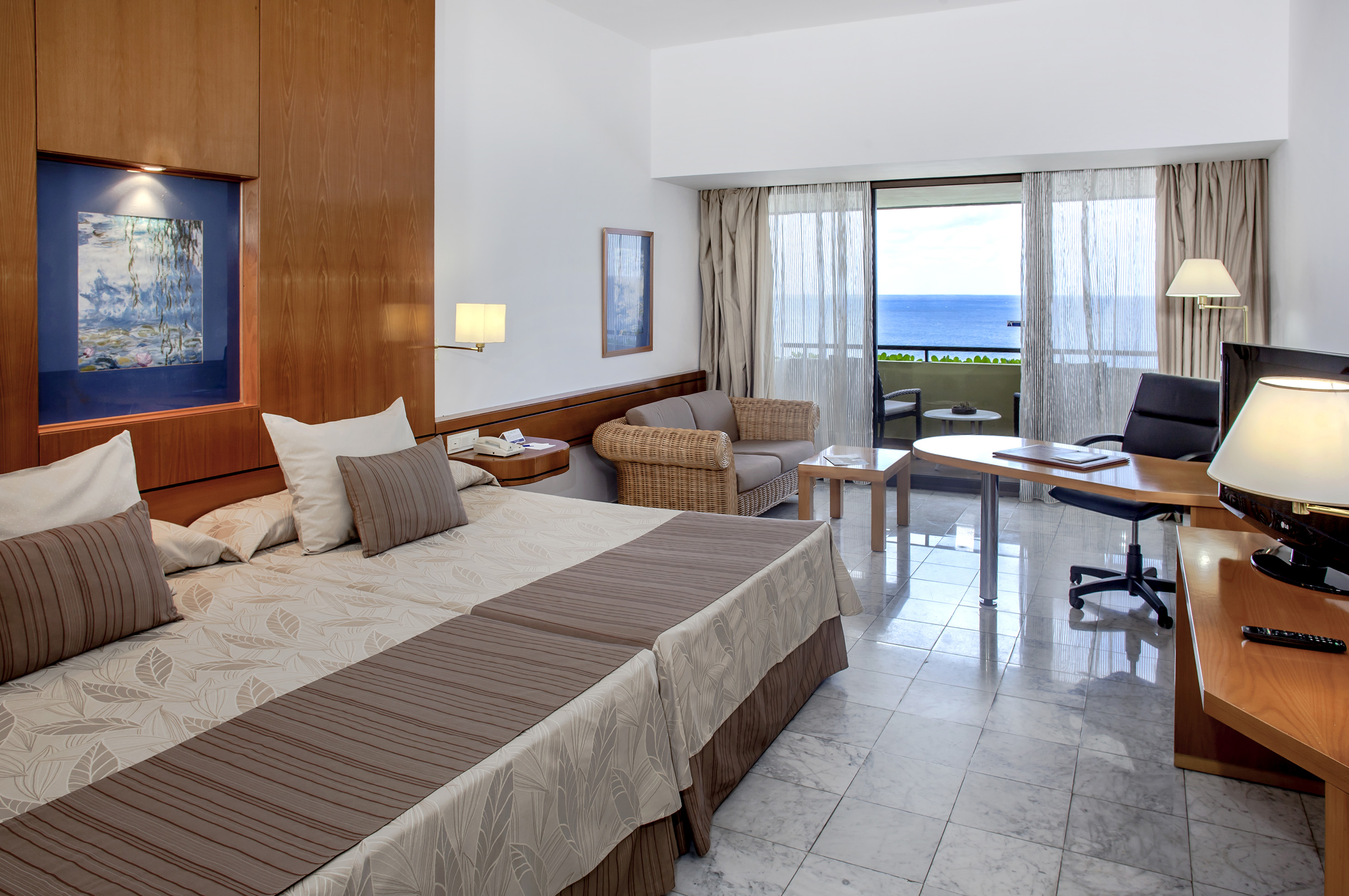 a room with a bed and a desk and chair