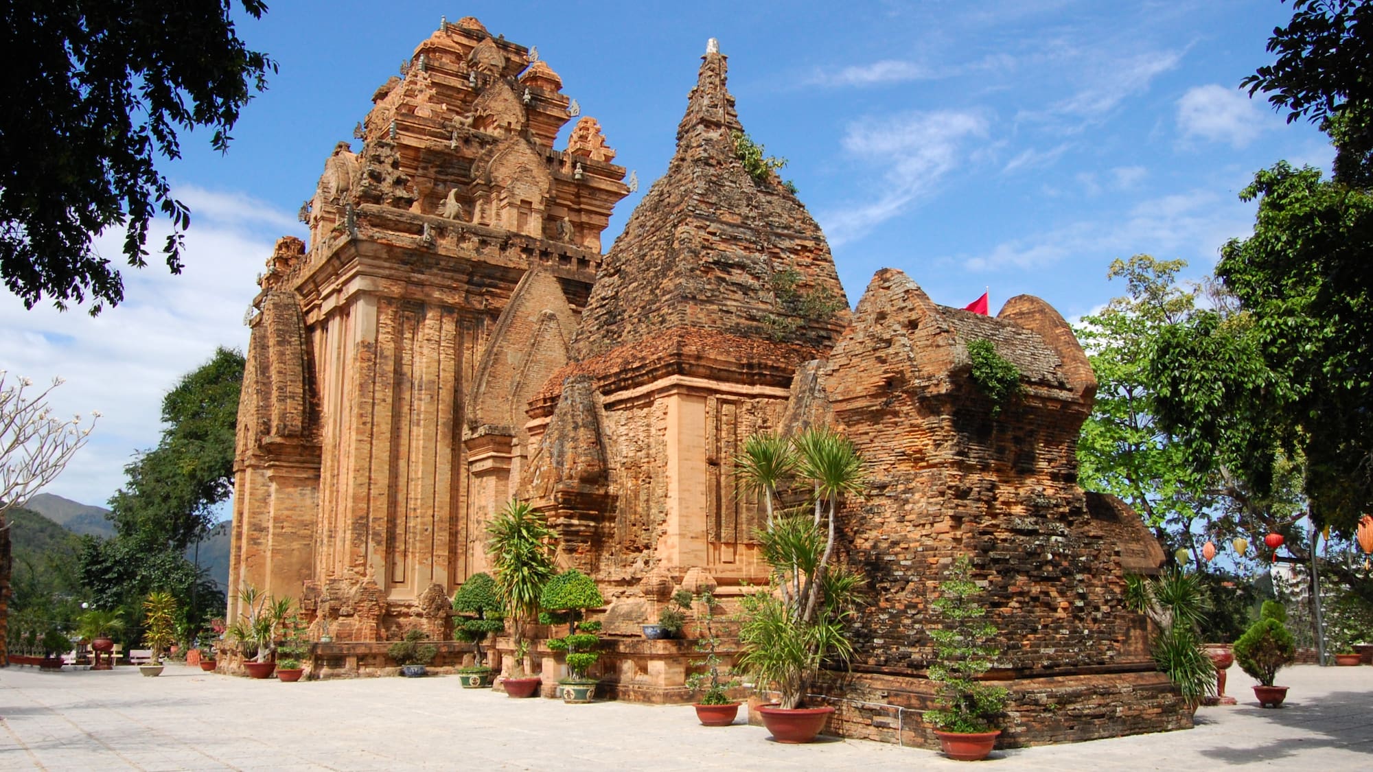 a stone building with trees and plants