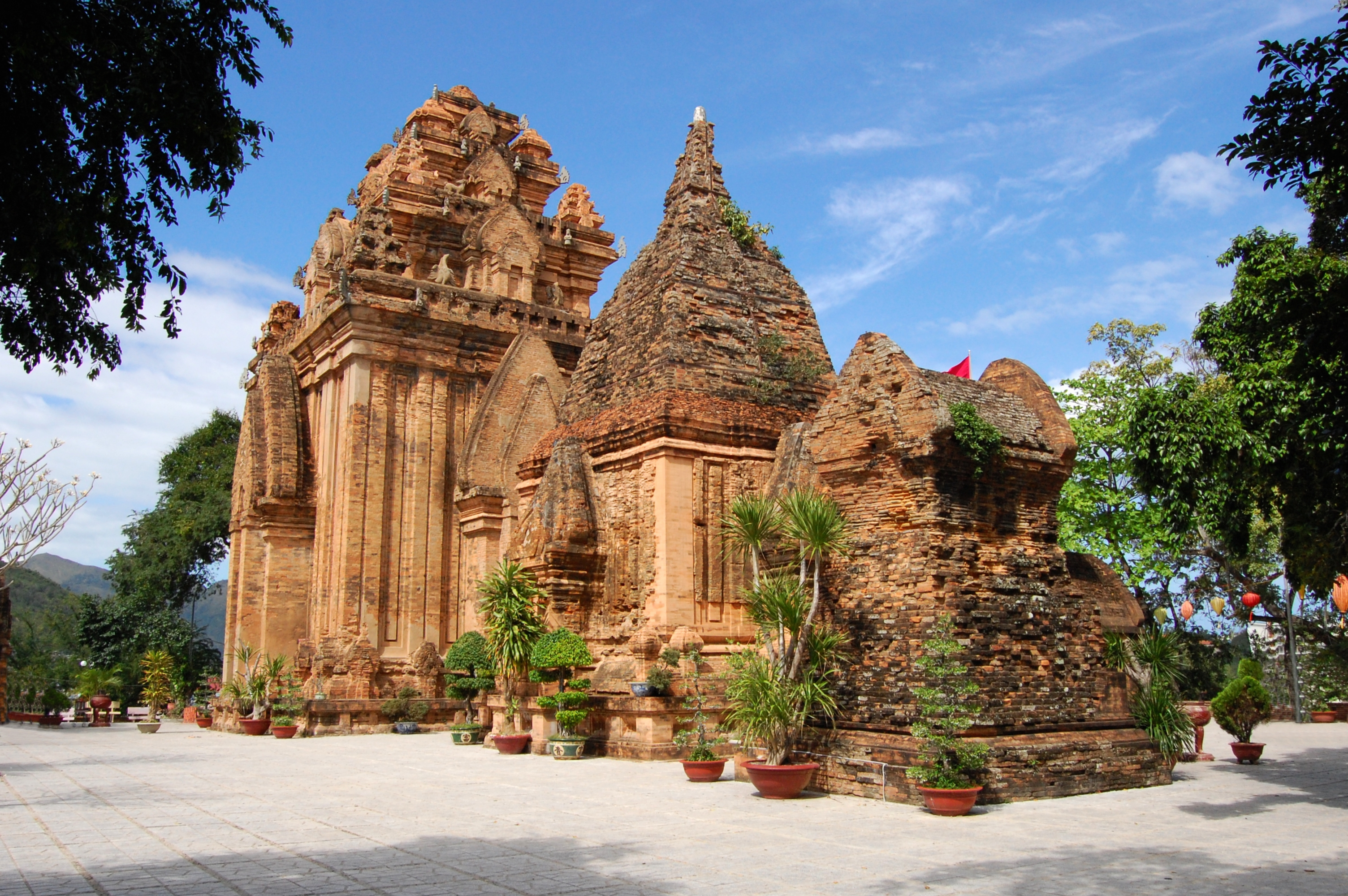 a stone building with trees and plants