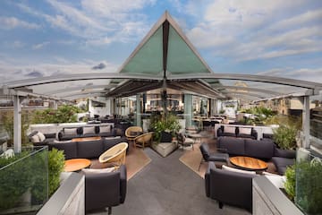 a roof top patio with furniture and tables