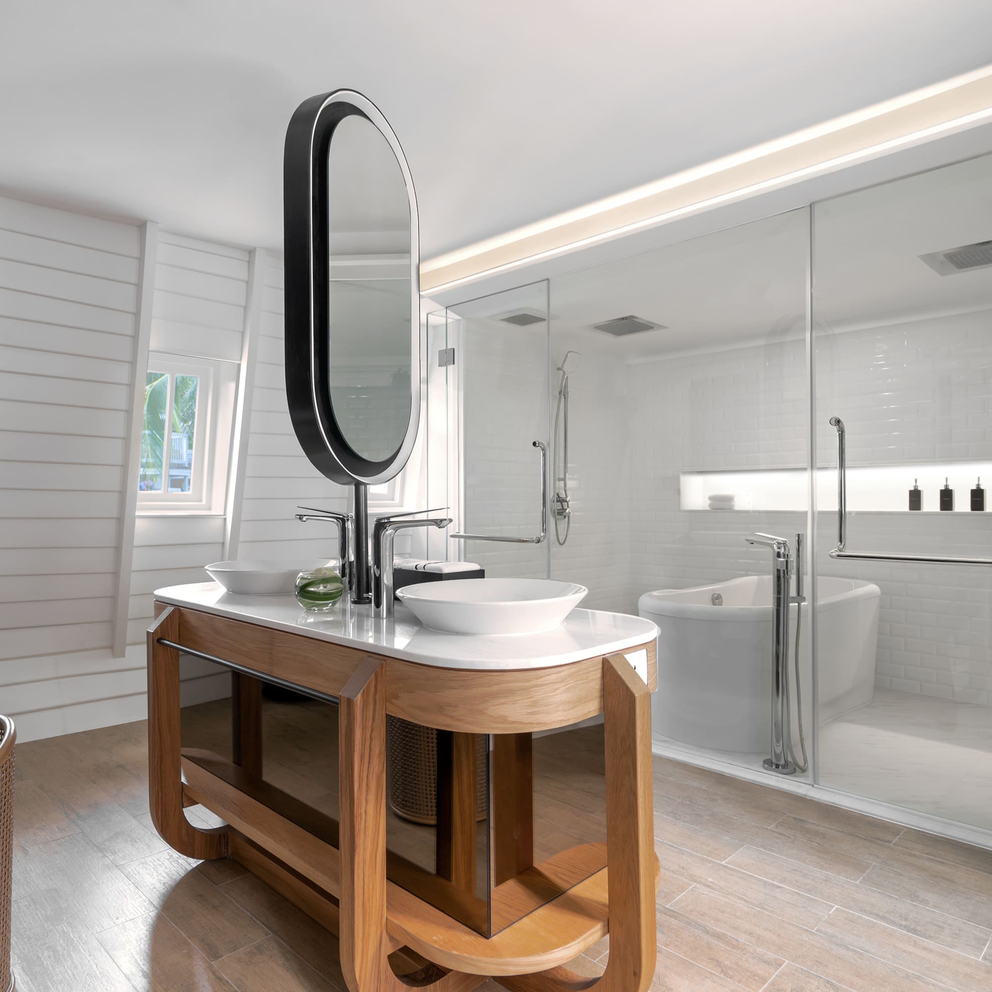 a bathroom with a large glass shower and a sink