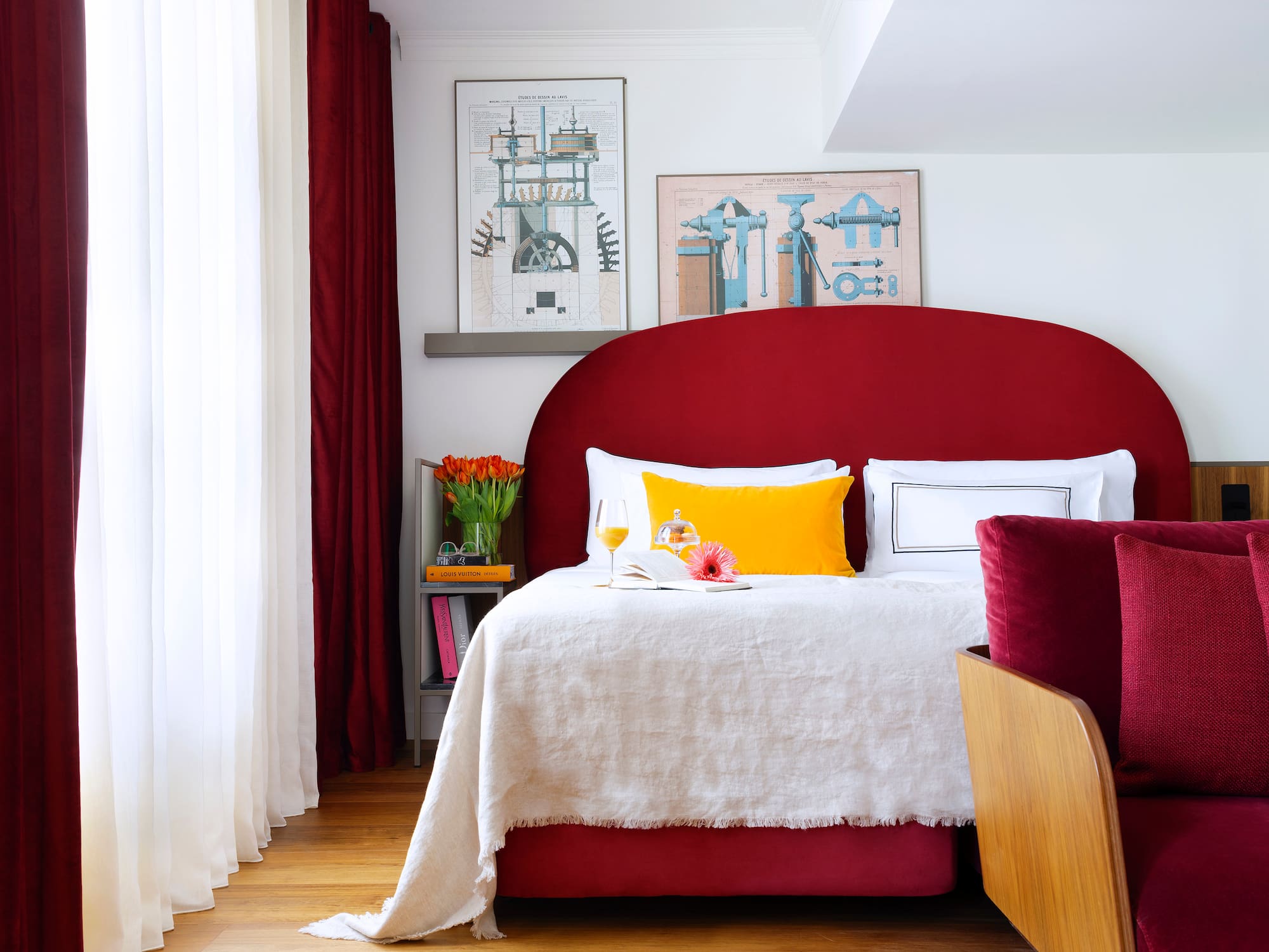 a bed with a red headboard and a red pillow