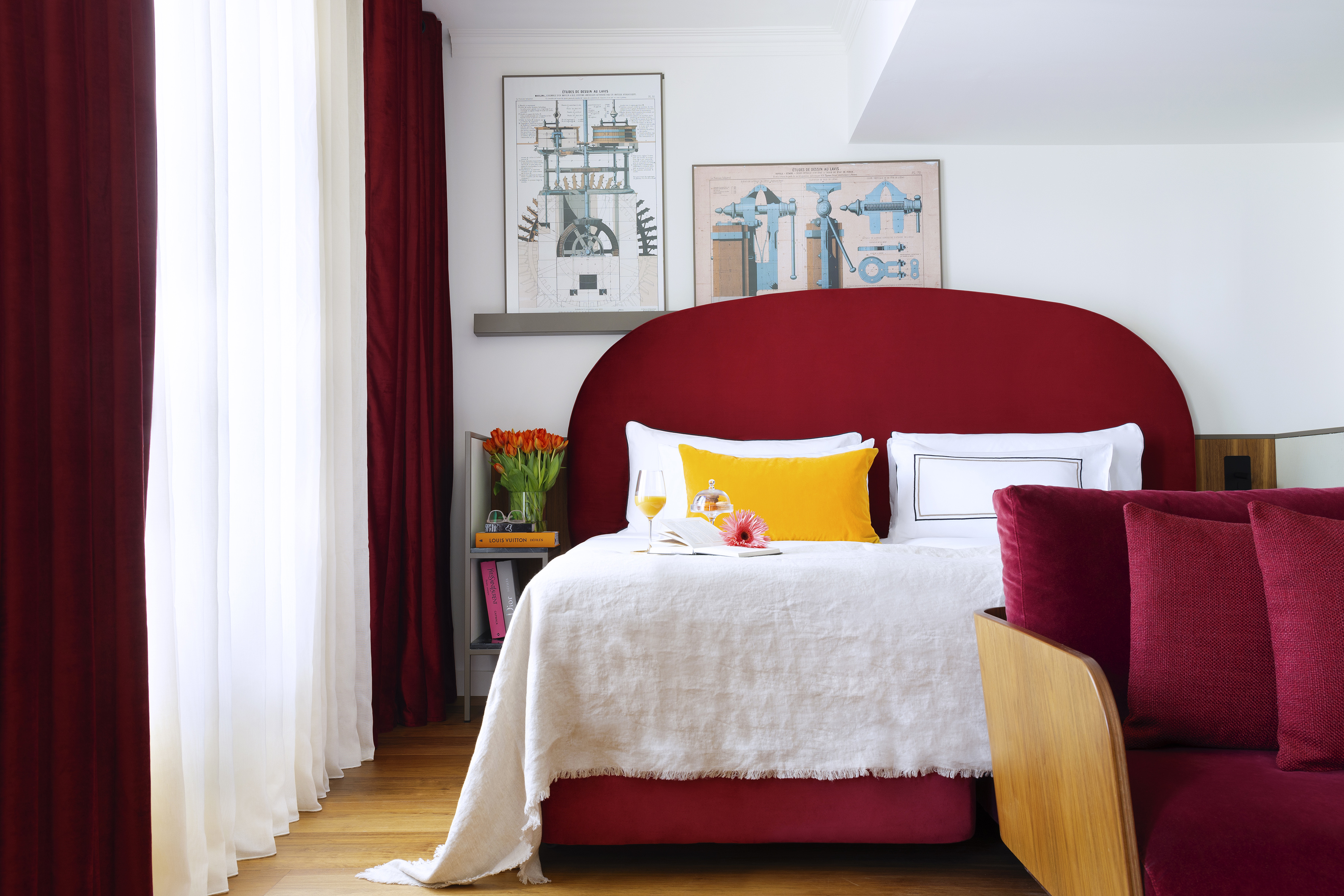 Modern red bedroom with comfortable bed, white linen, yellow pillow, and red curtains.