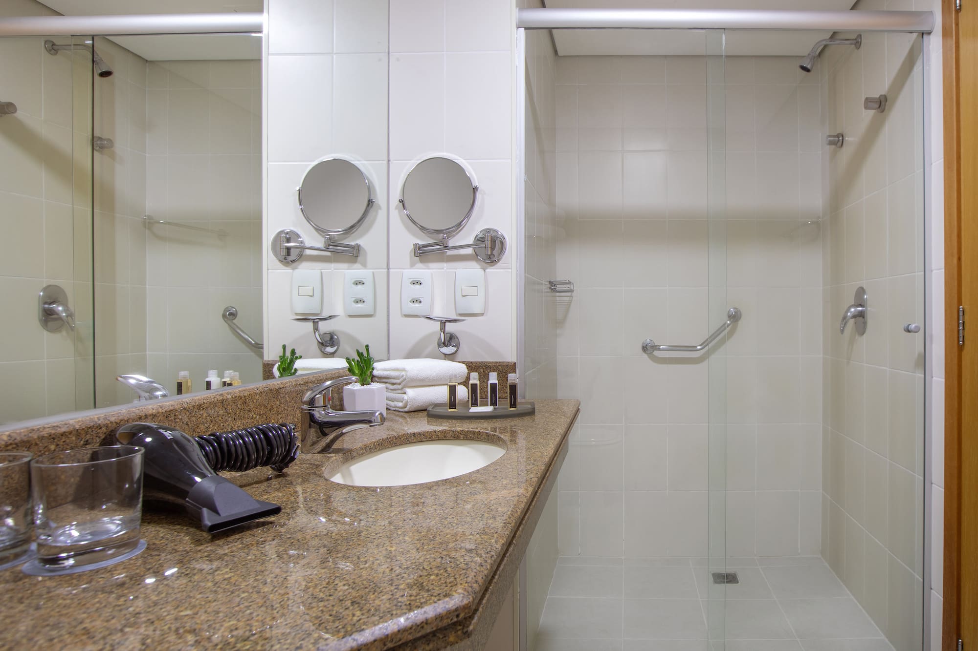 a bathroom with a shower and a sink