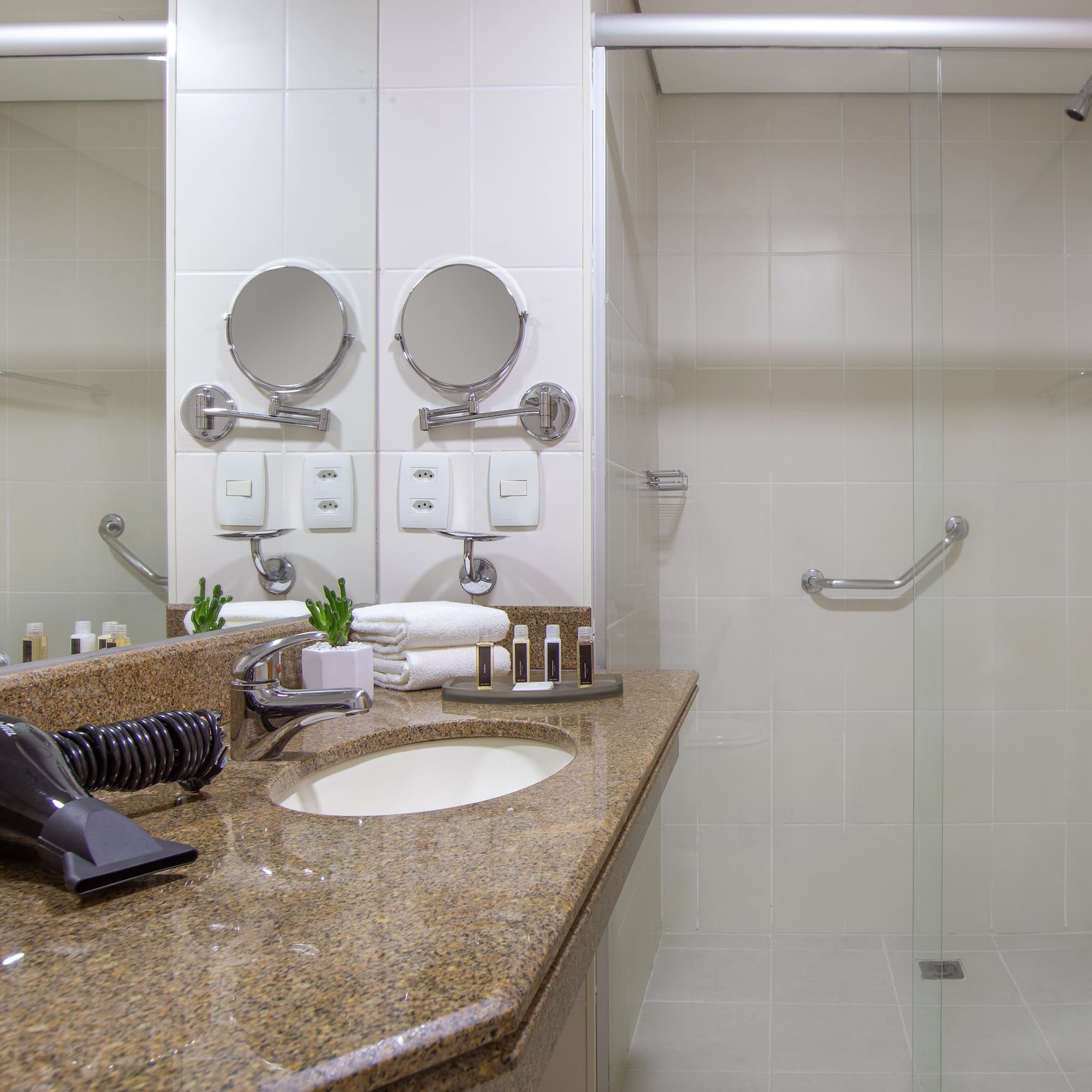 a bathroom with a shower and a sink