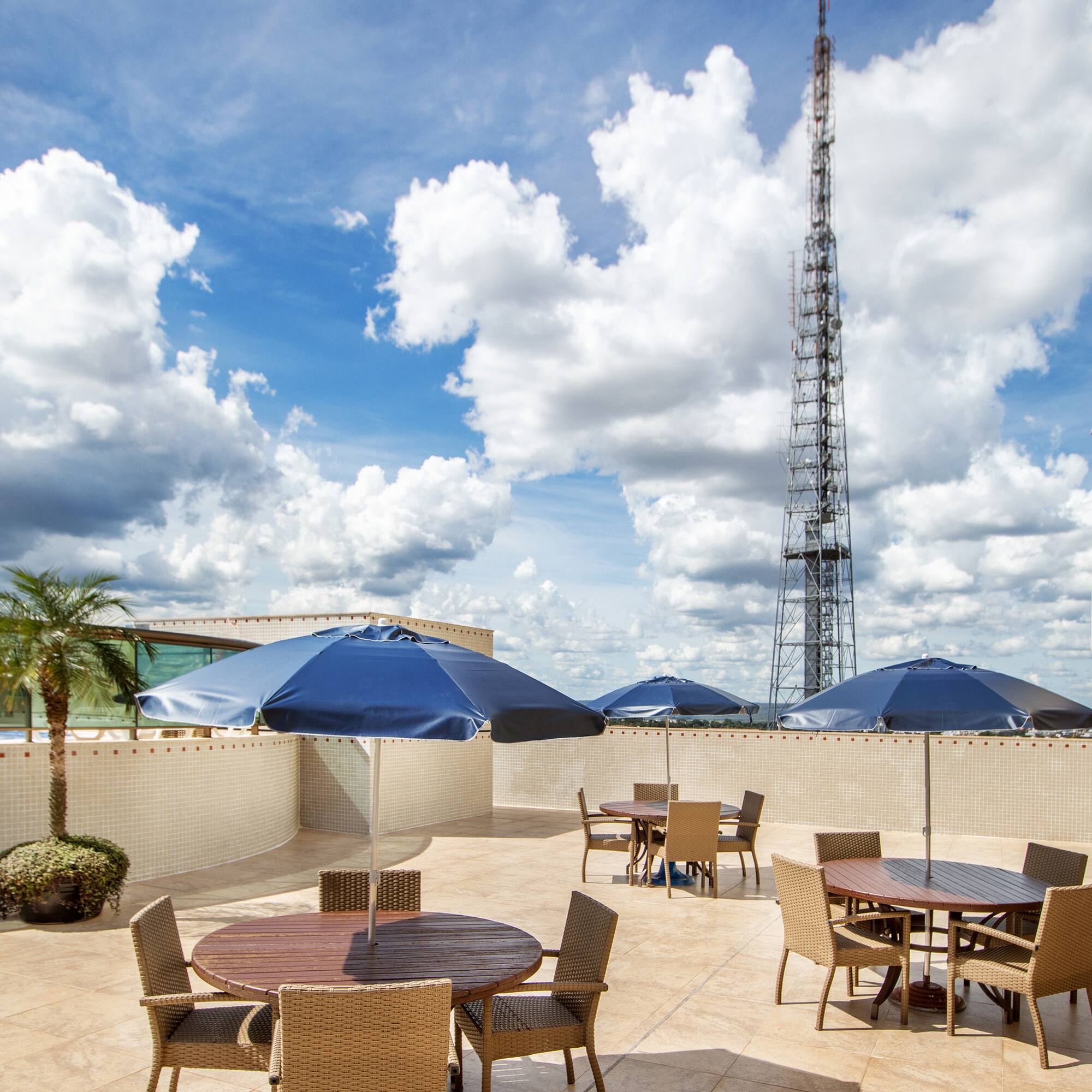 a patio with tables and umbrellas