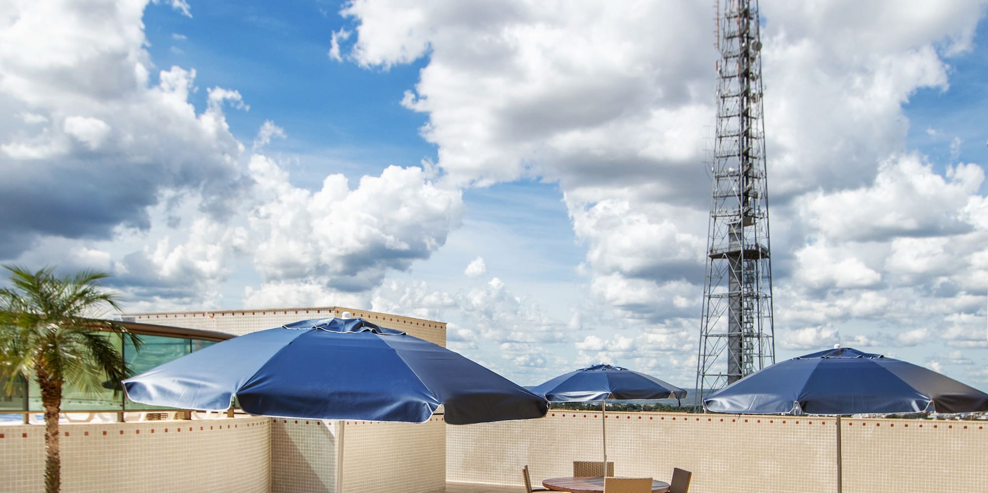 a patio with tables and umbrellas