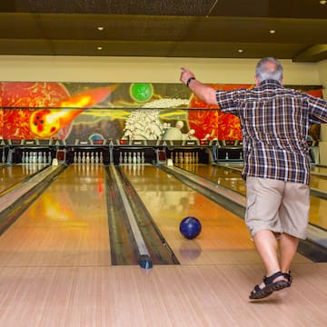 a man throwing a bowling ball