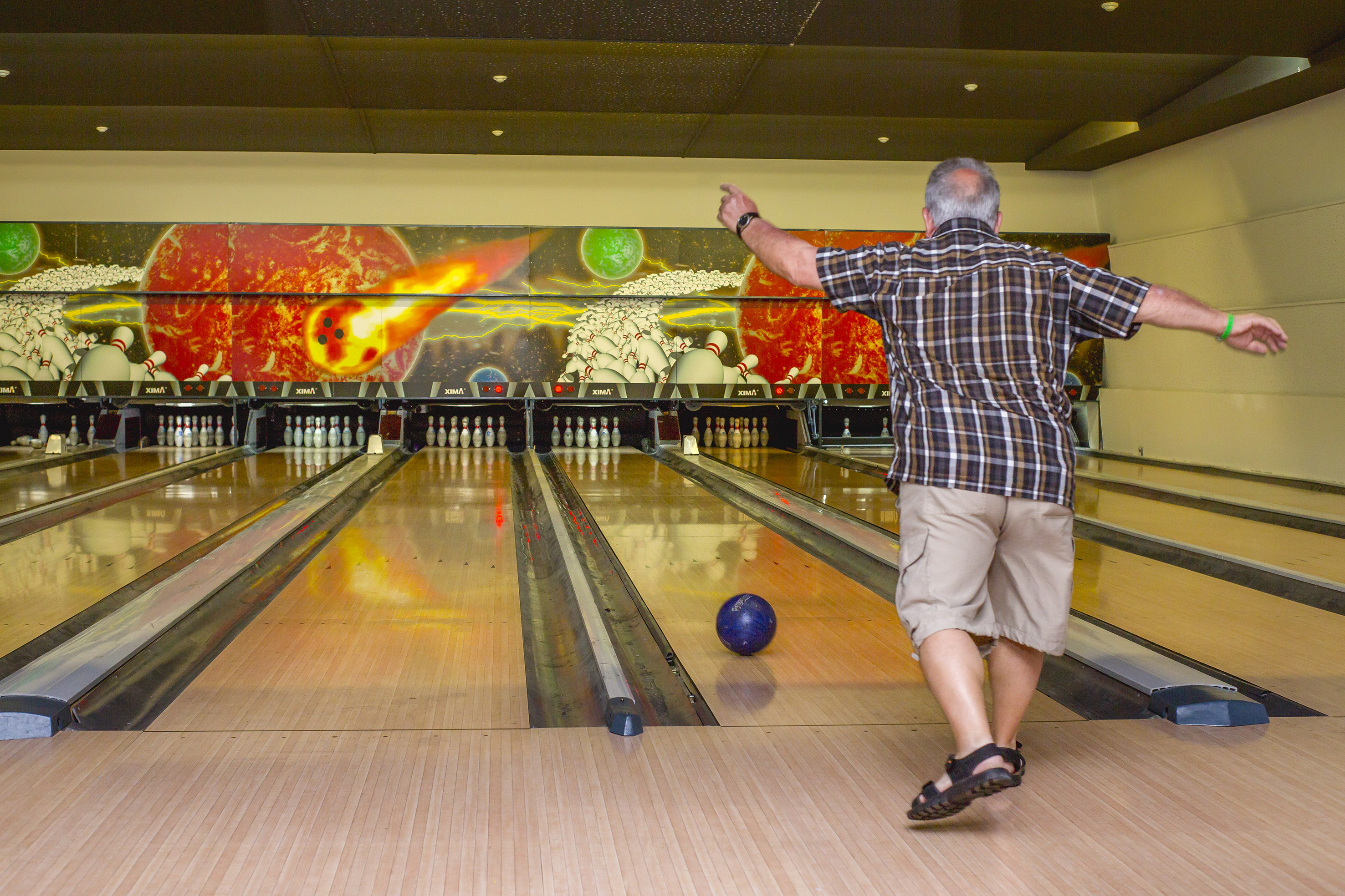 a man throwing a bowling ball
