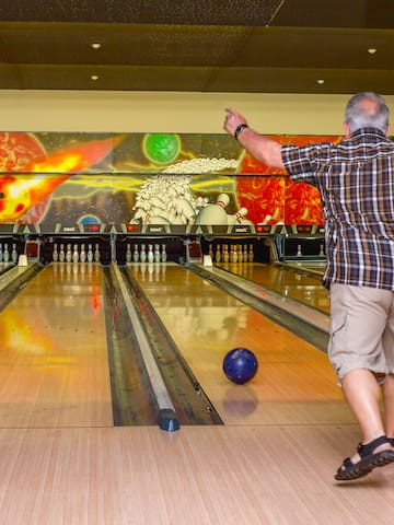 a man throwing a bowling ball