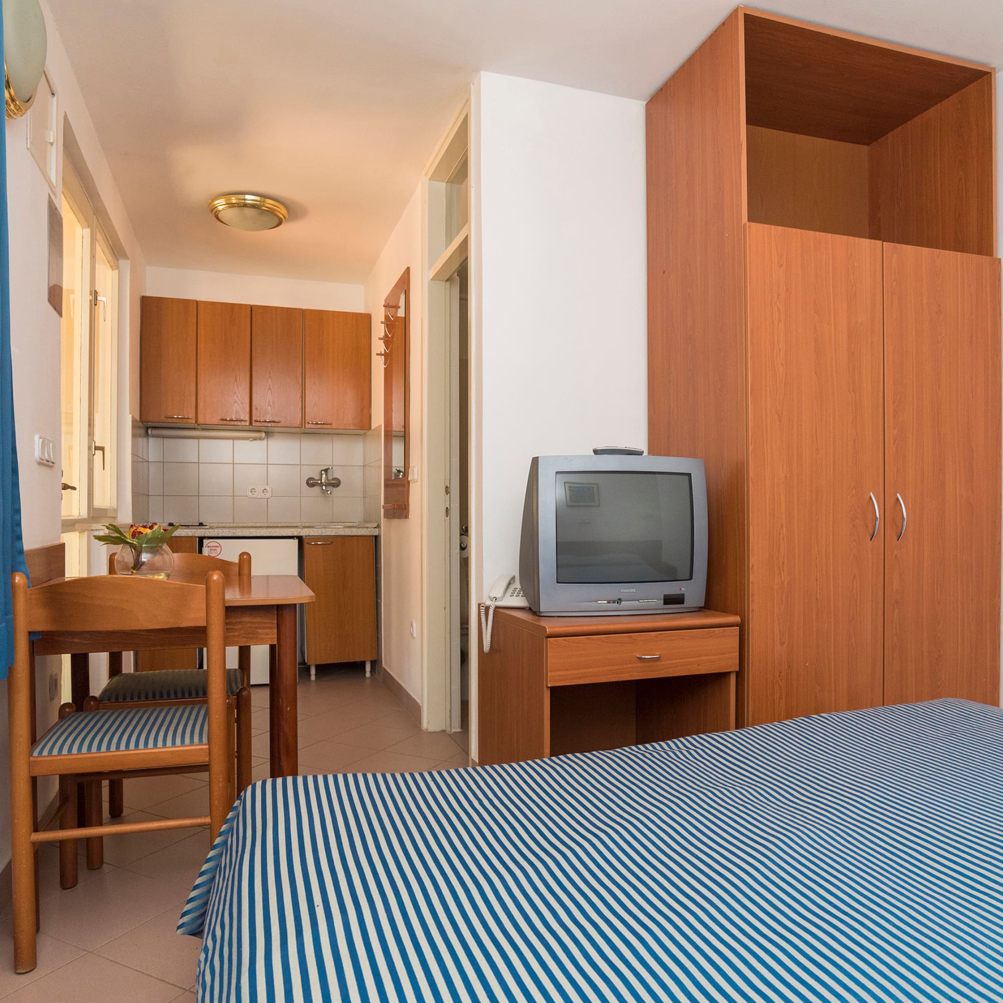 a room with a bed and a table and chair