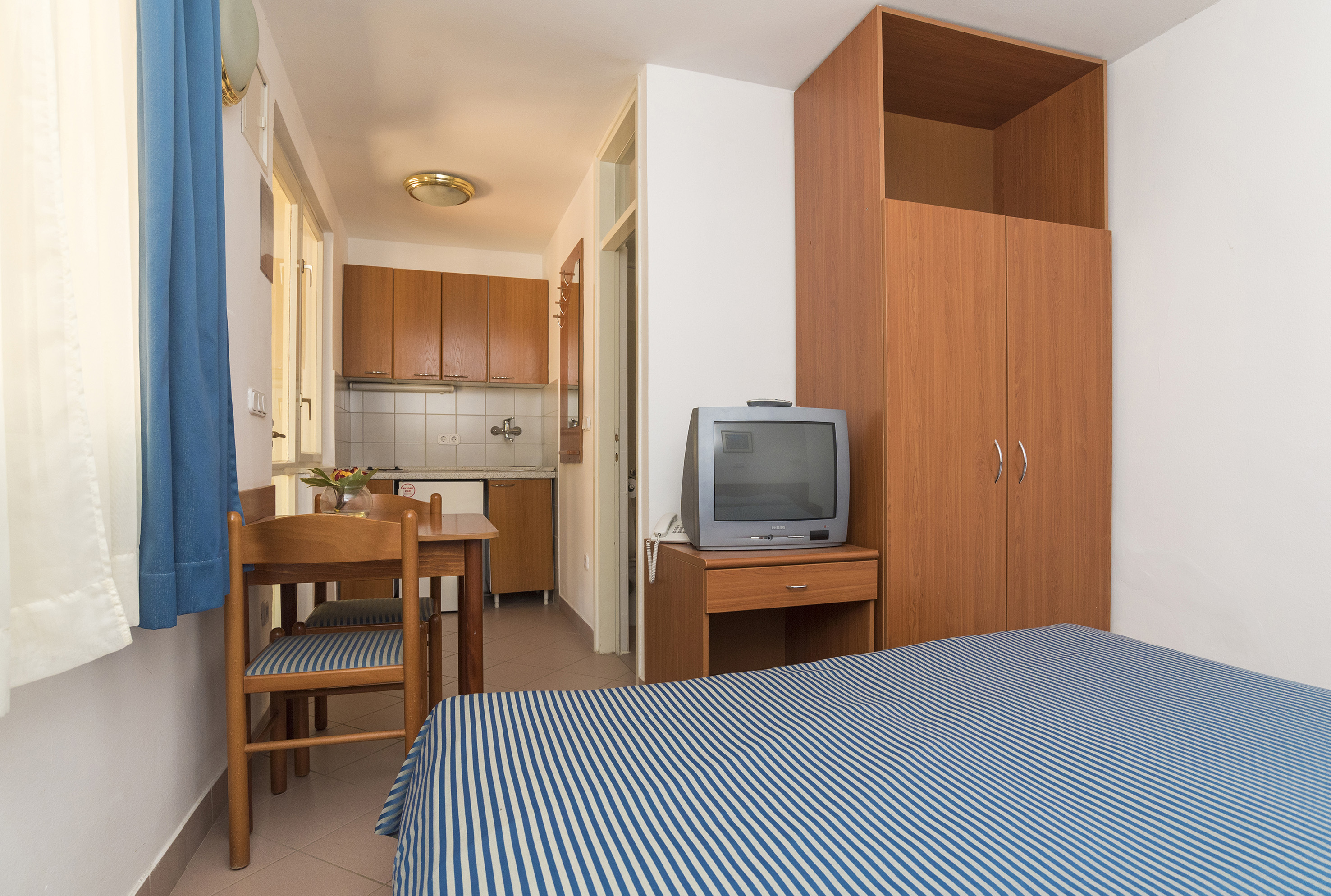 a room with a bed and a table and chair