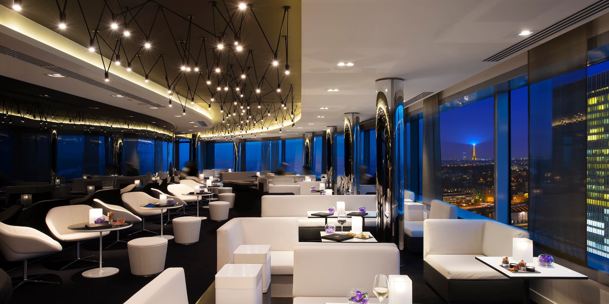 a room with white furniture and lights