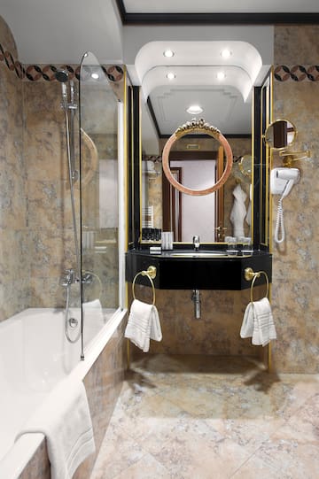 a bathroom with a mirror and a bathtub