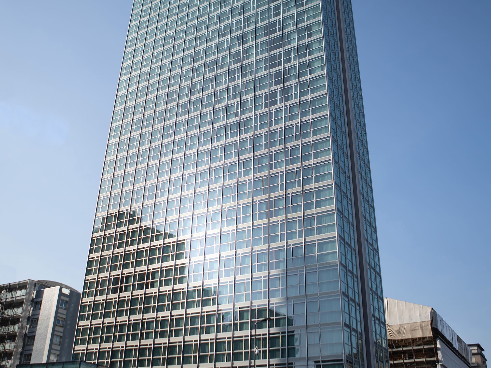 a tall glass building with many windows