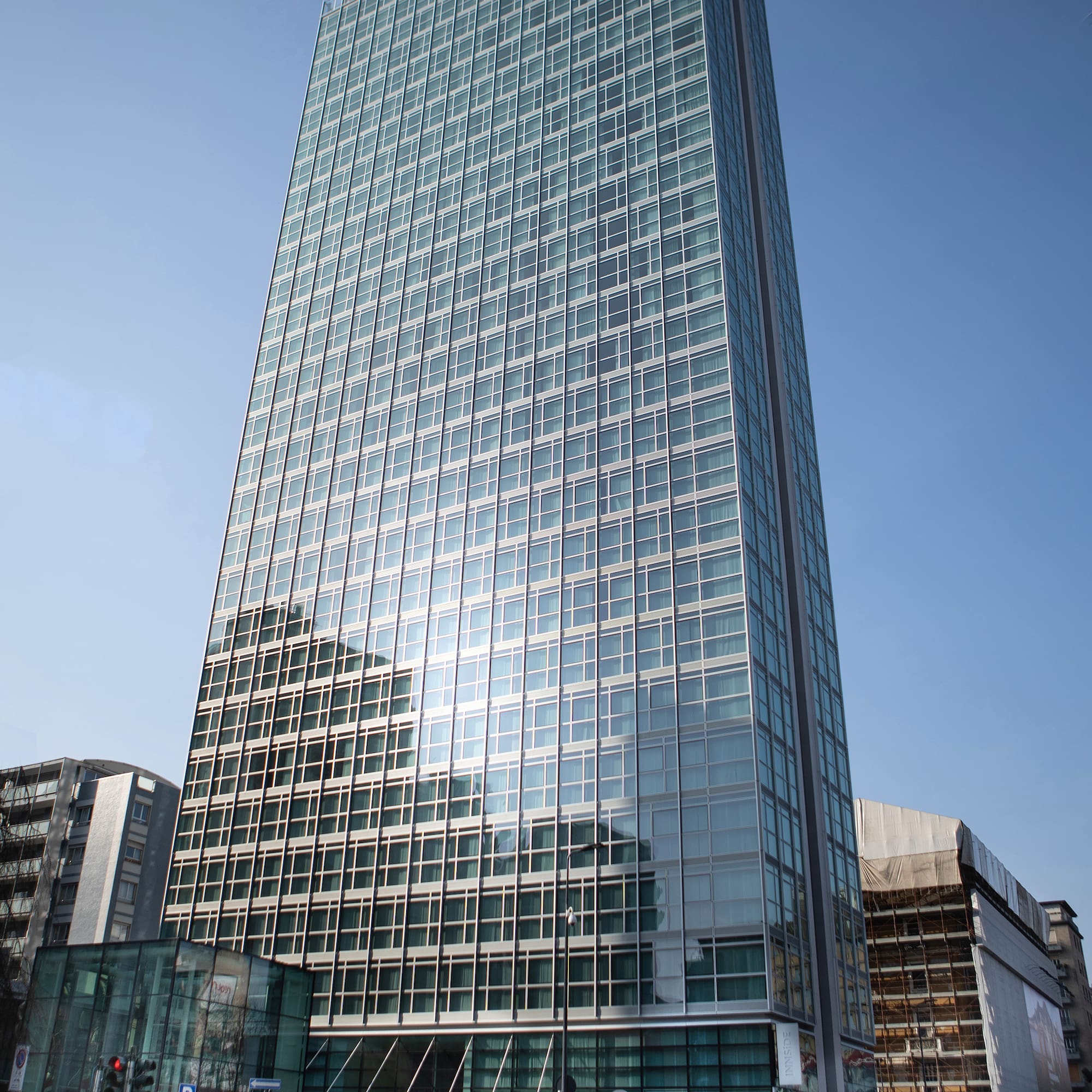 a tall glass building with many windows