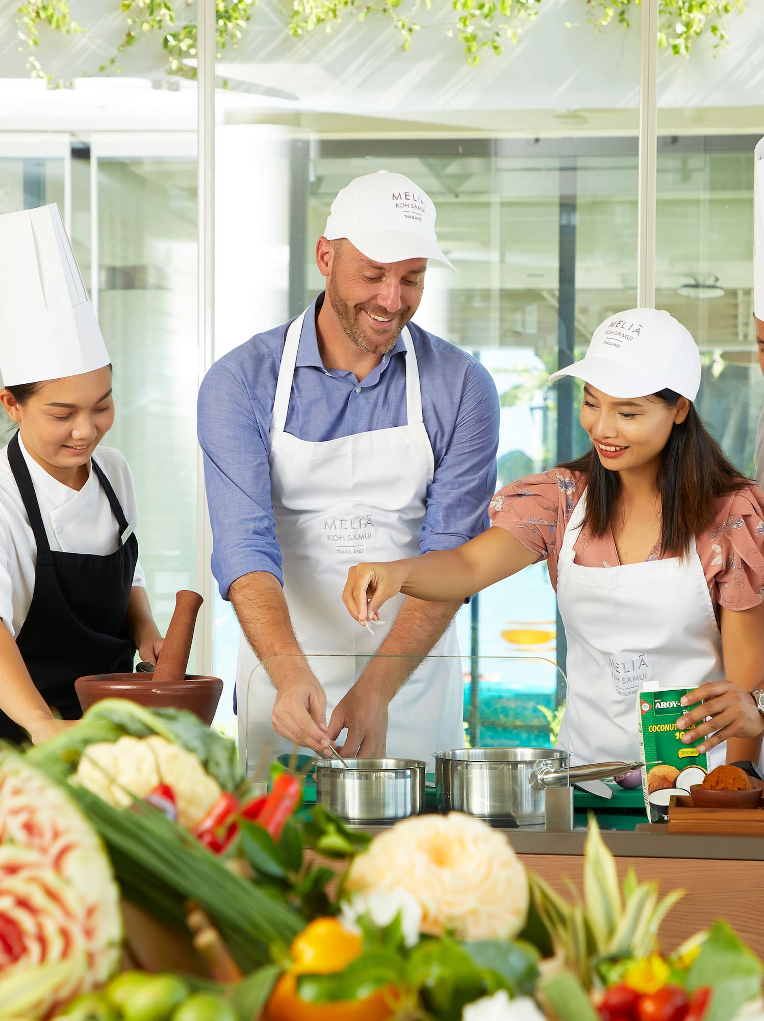 a group of people in aprons cooking