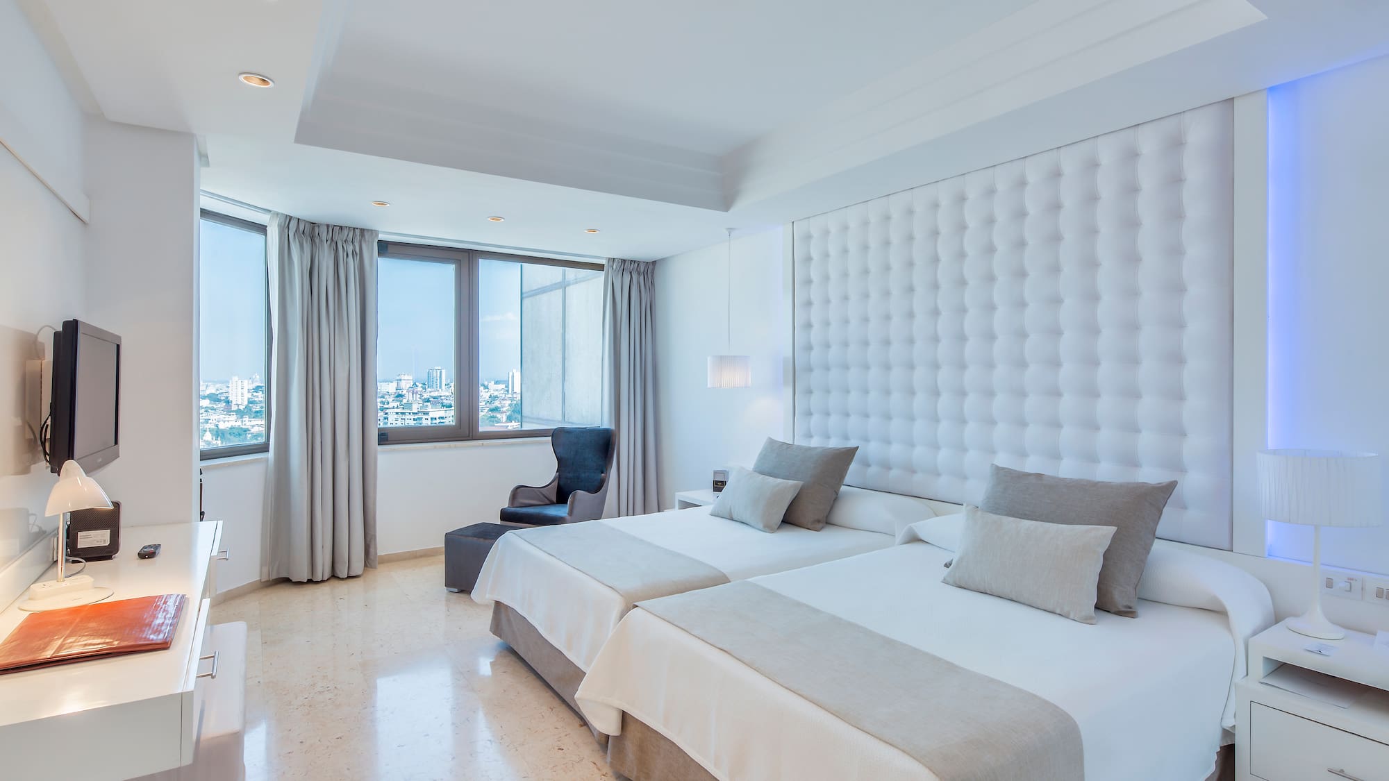 a room with two beds and a window