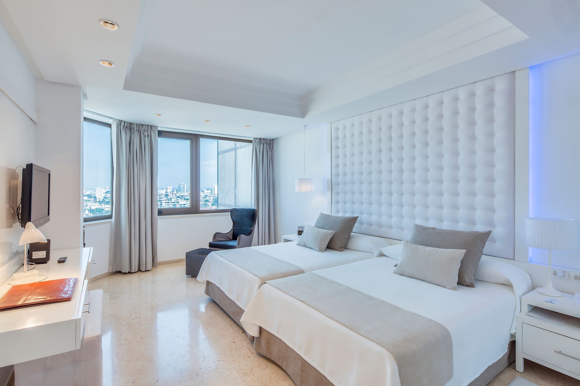 a room with two beds and a window