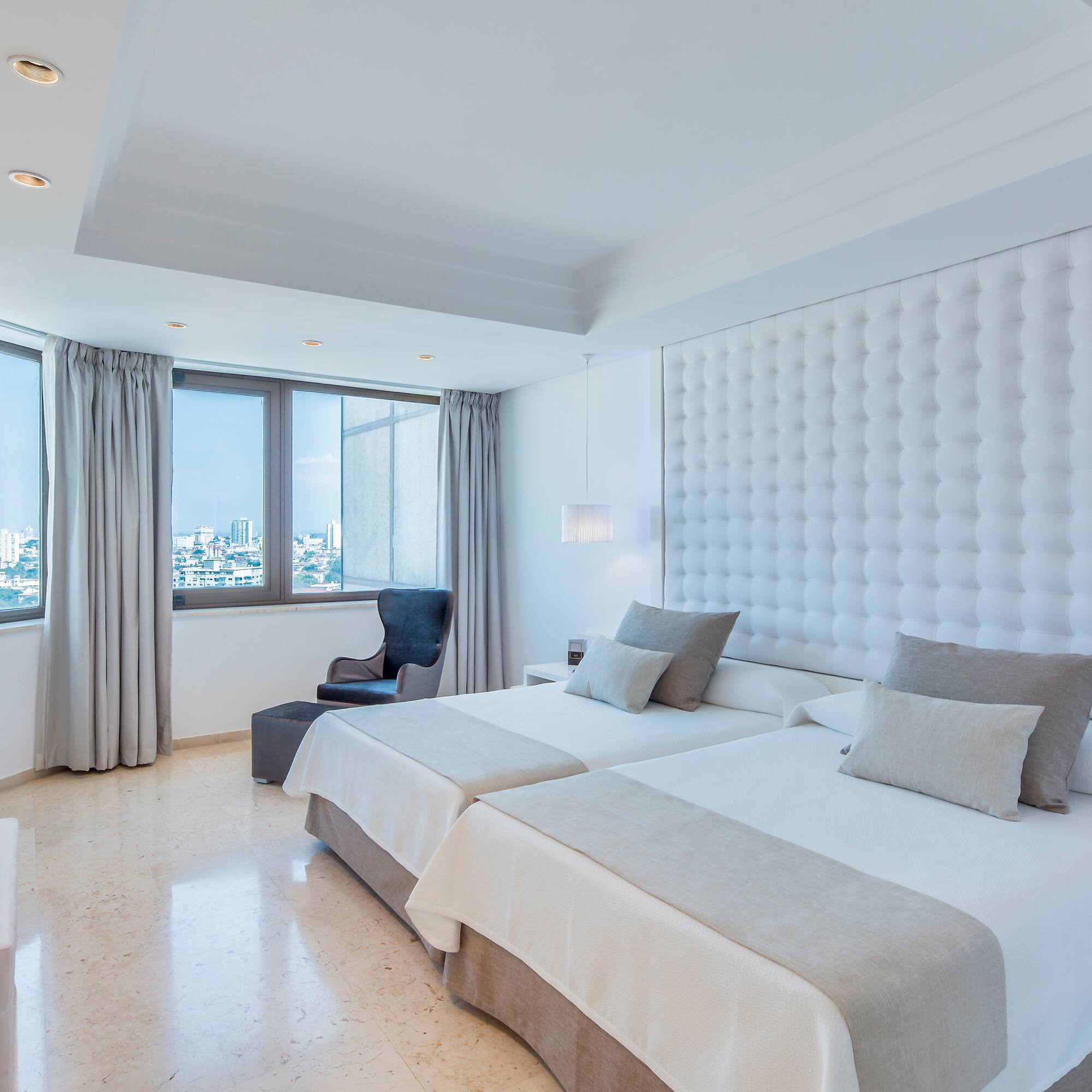 a room with two beds and a window