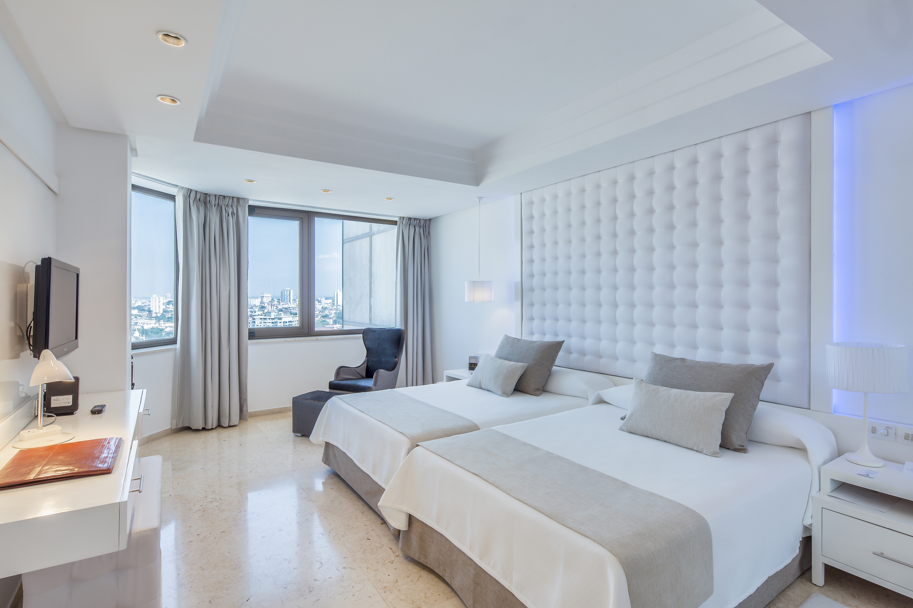 a room with two beds and a window