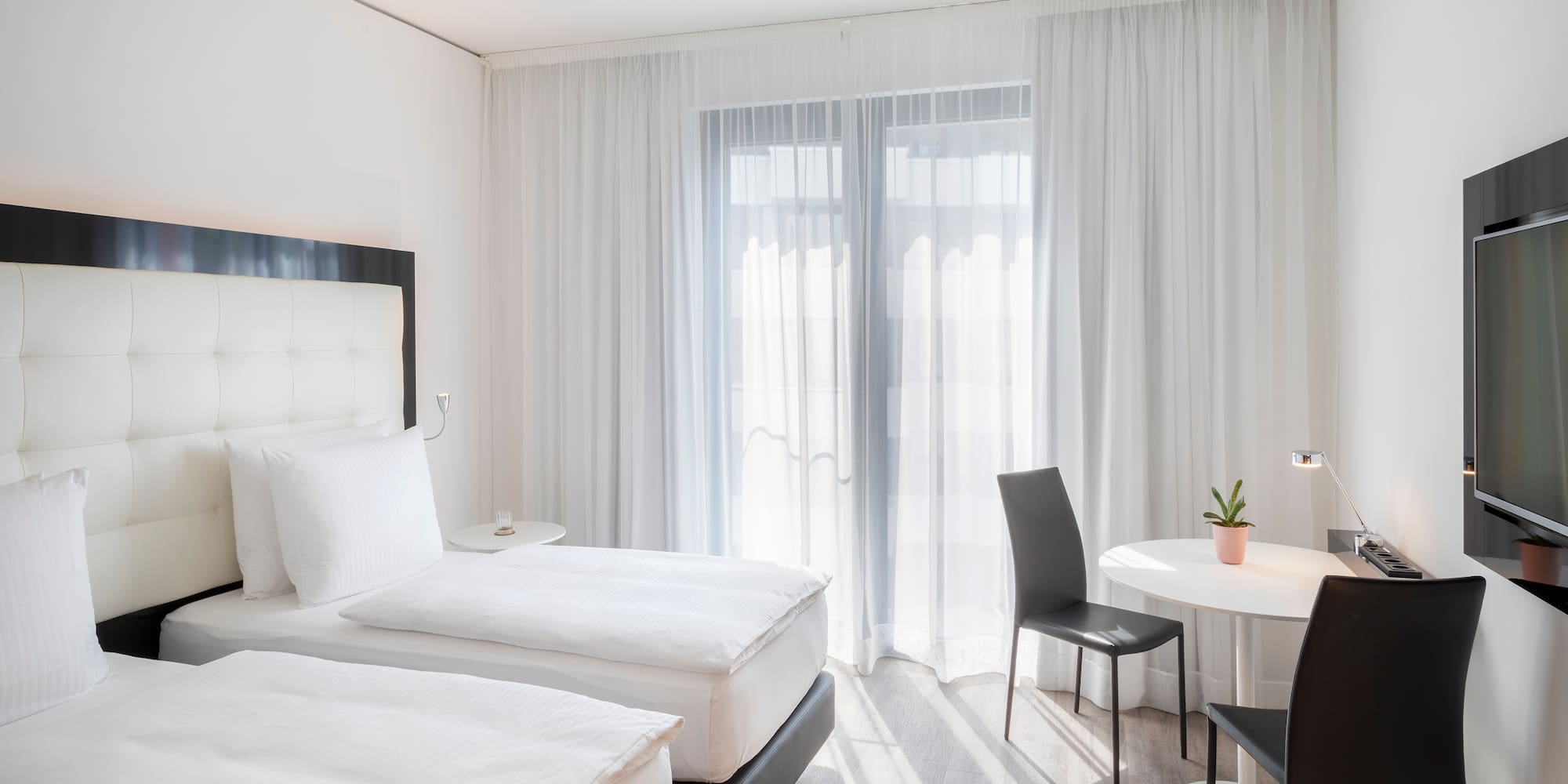 a room with two beds and a table