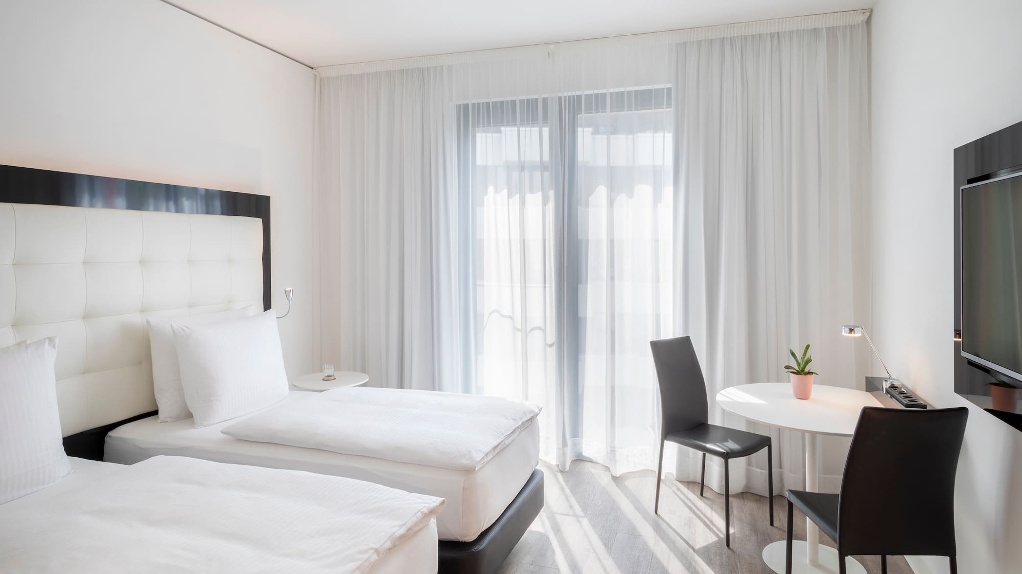 a room with two beds and a table