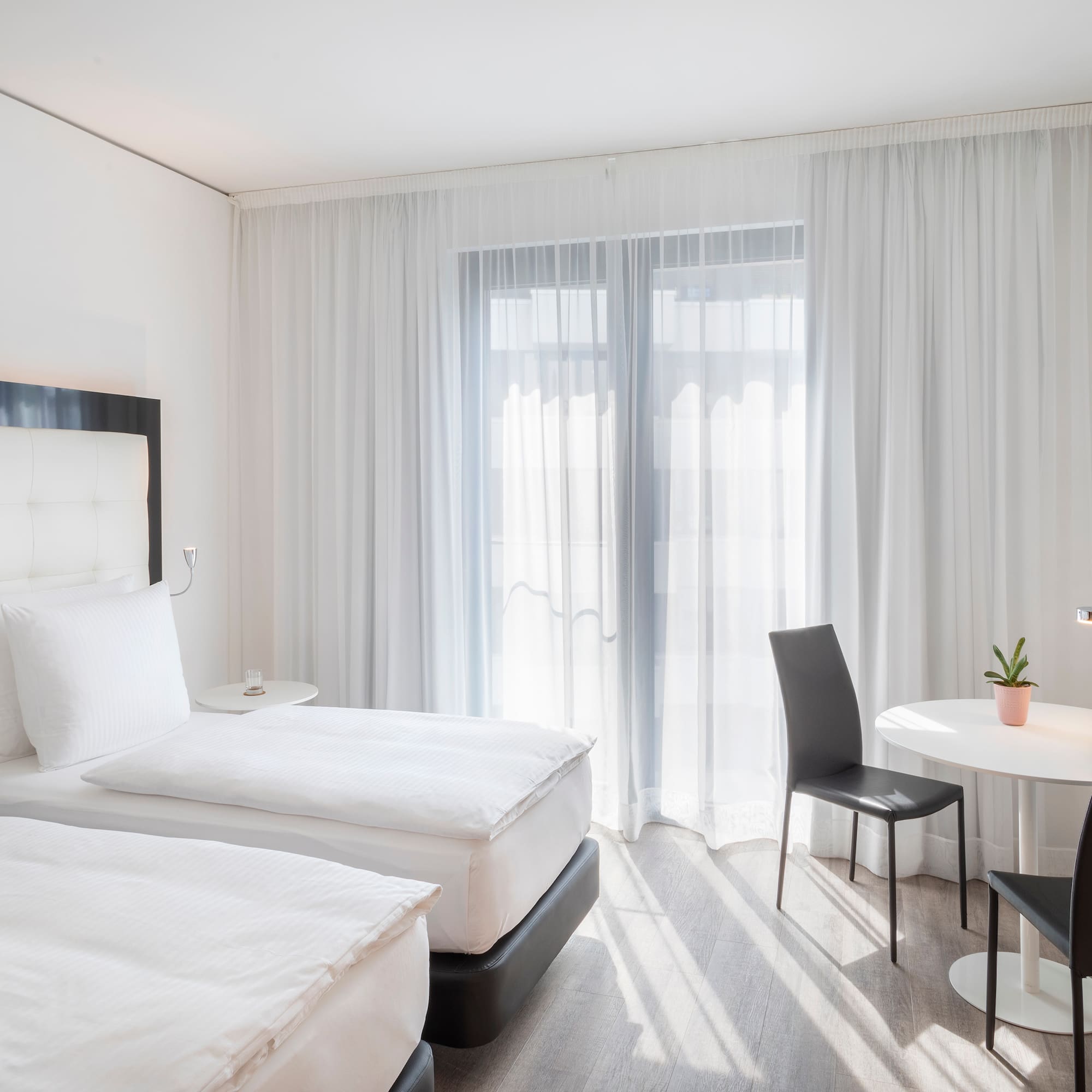 a room with two beds and a table