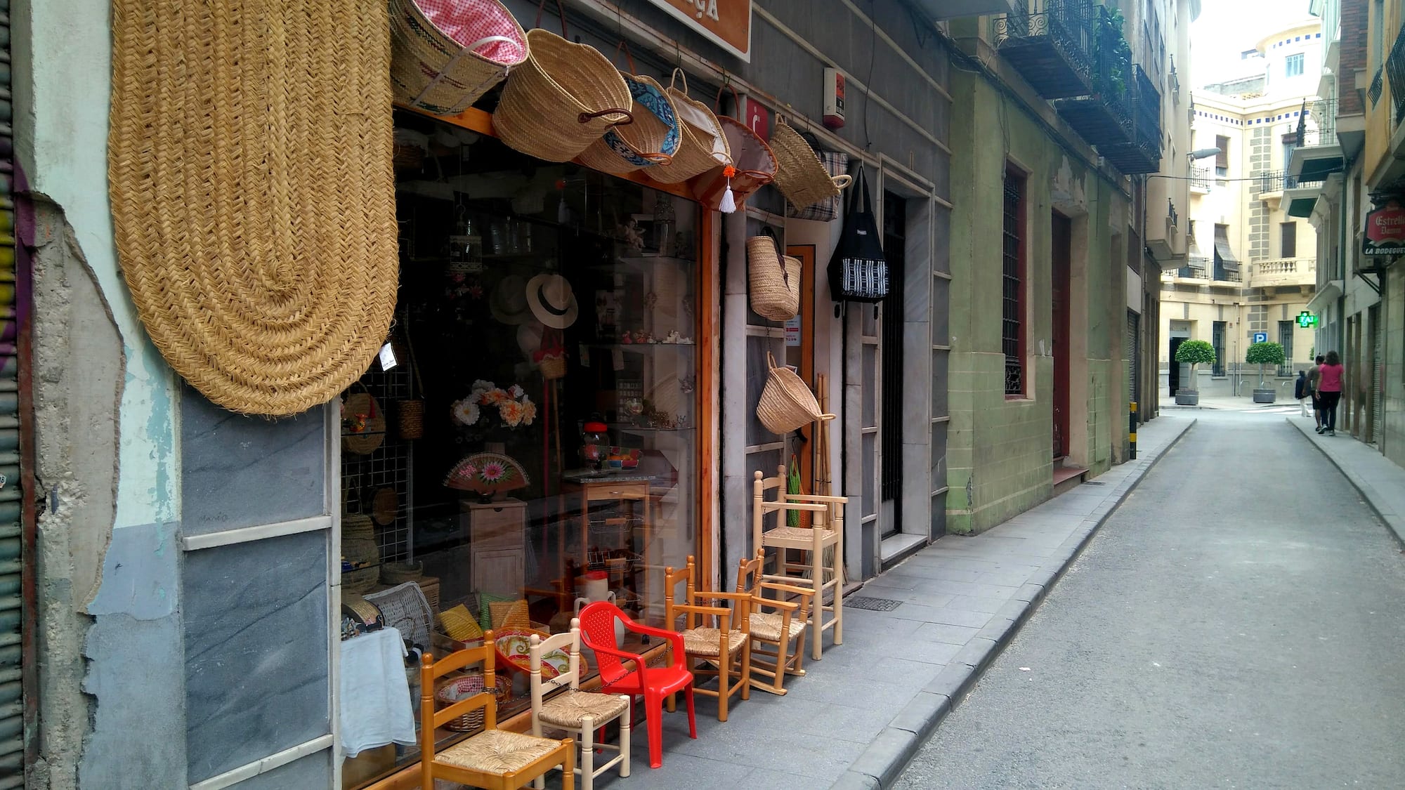 a storefront with chairs and baskets