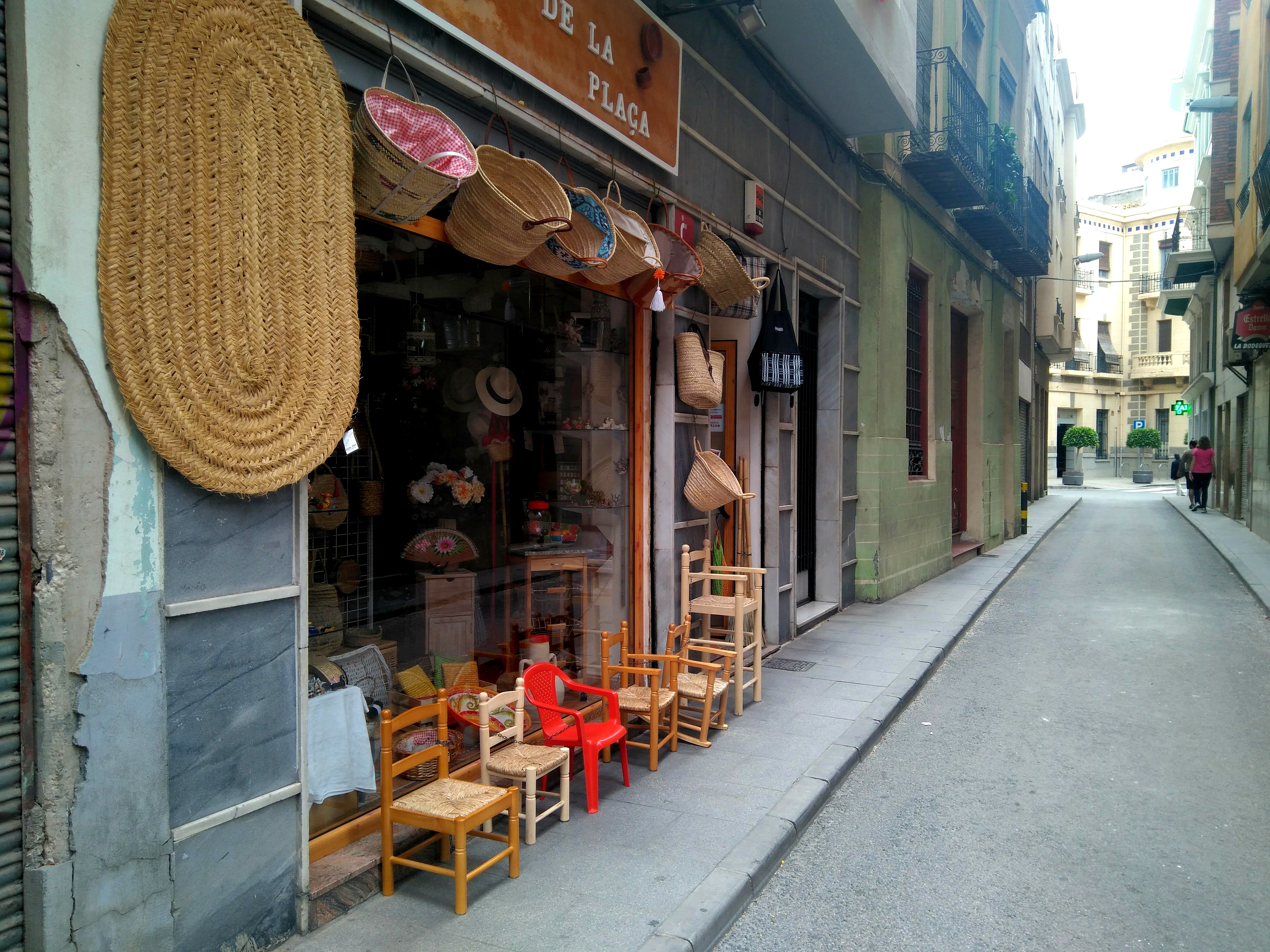 a storefront with chairs and baskets
