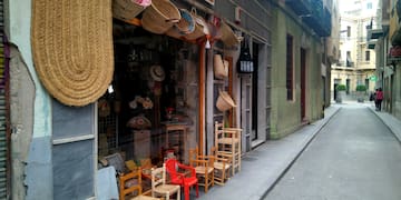 a storefront with chairs and baskets