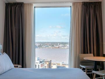 a room with a view of a city and a river