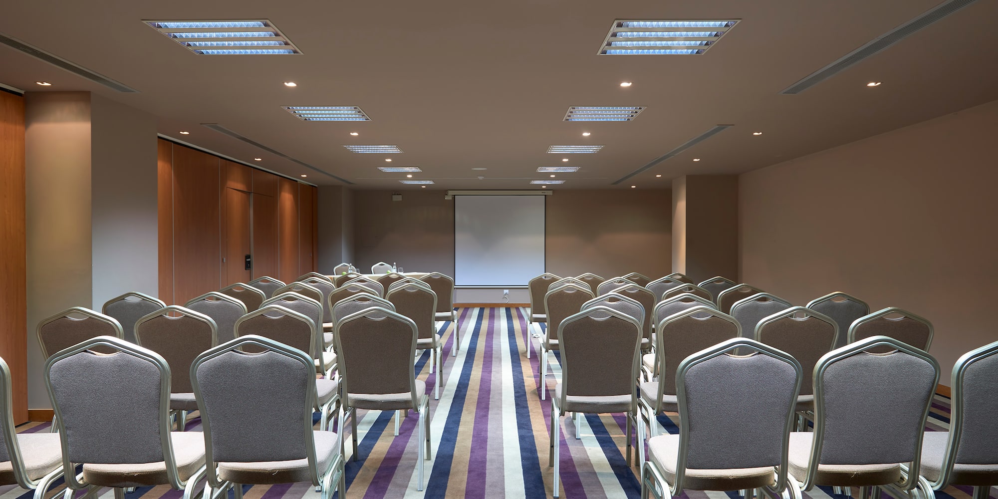 a room with chairs and a projector screen