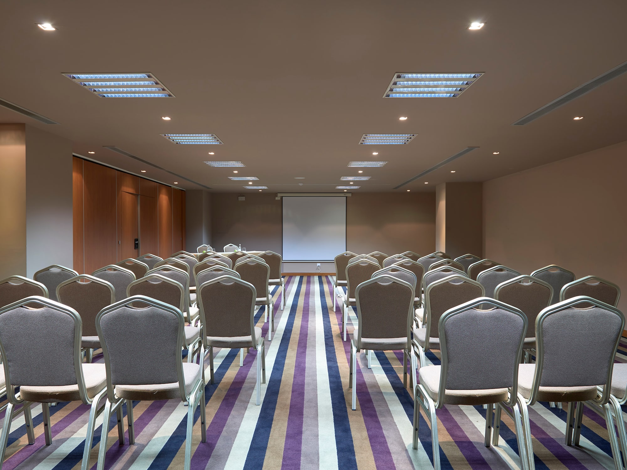 a room with chairs and a projector screen