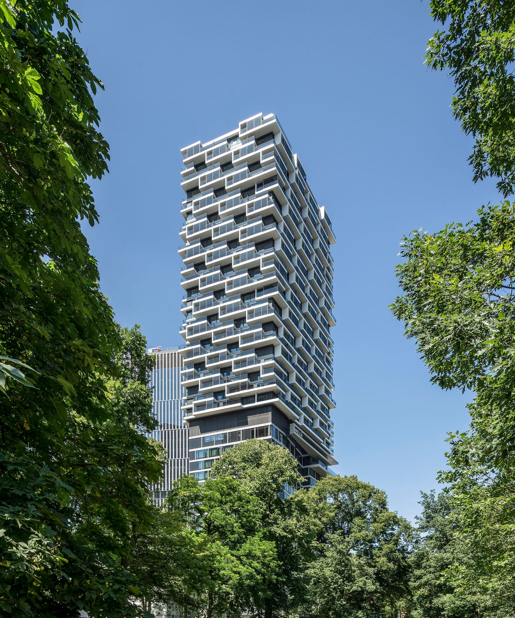 a tall building with trees around it