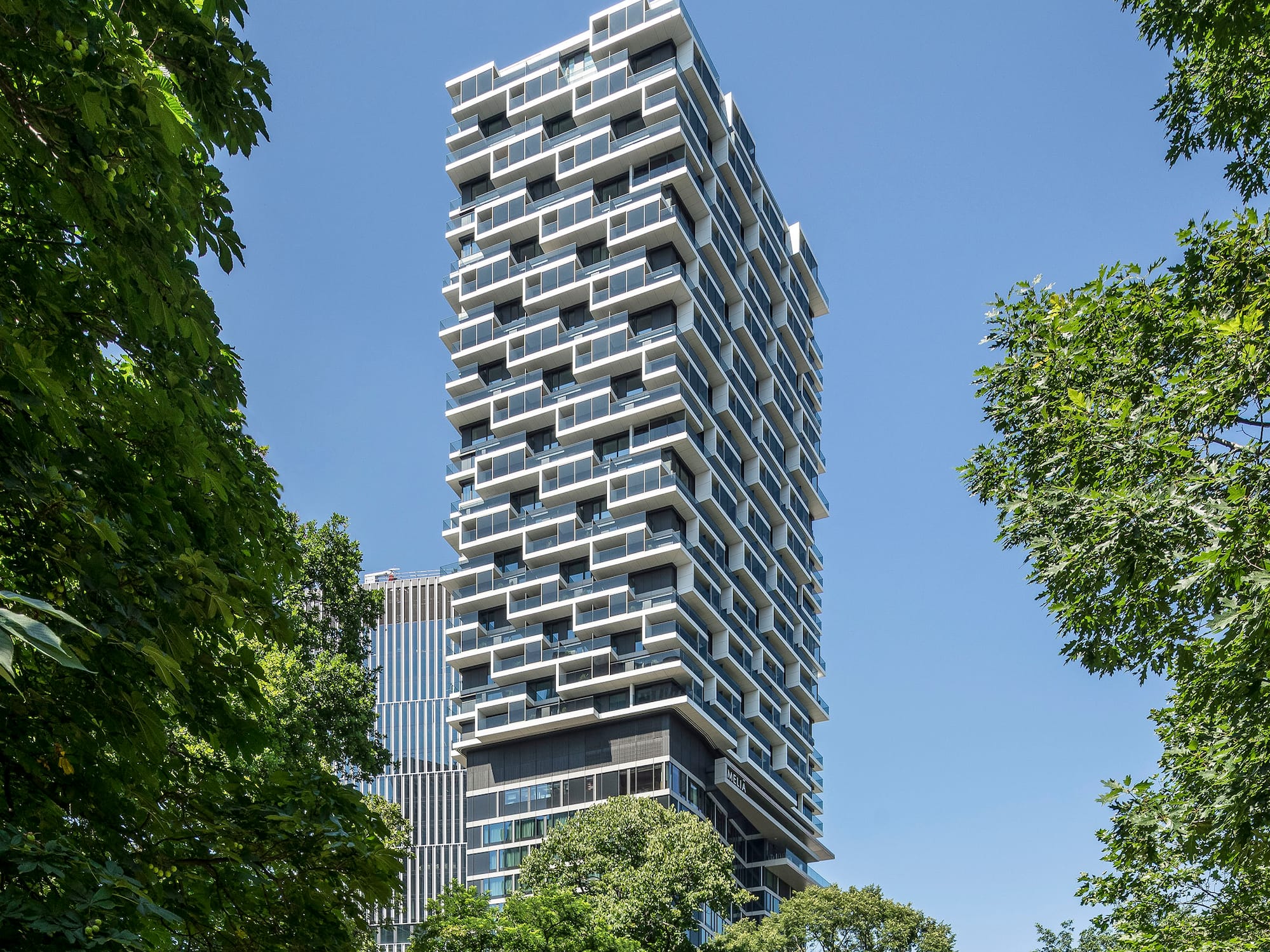 a tall building with trees around it