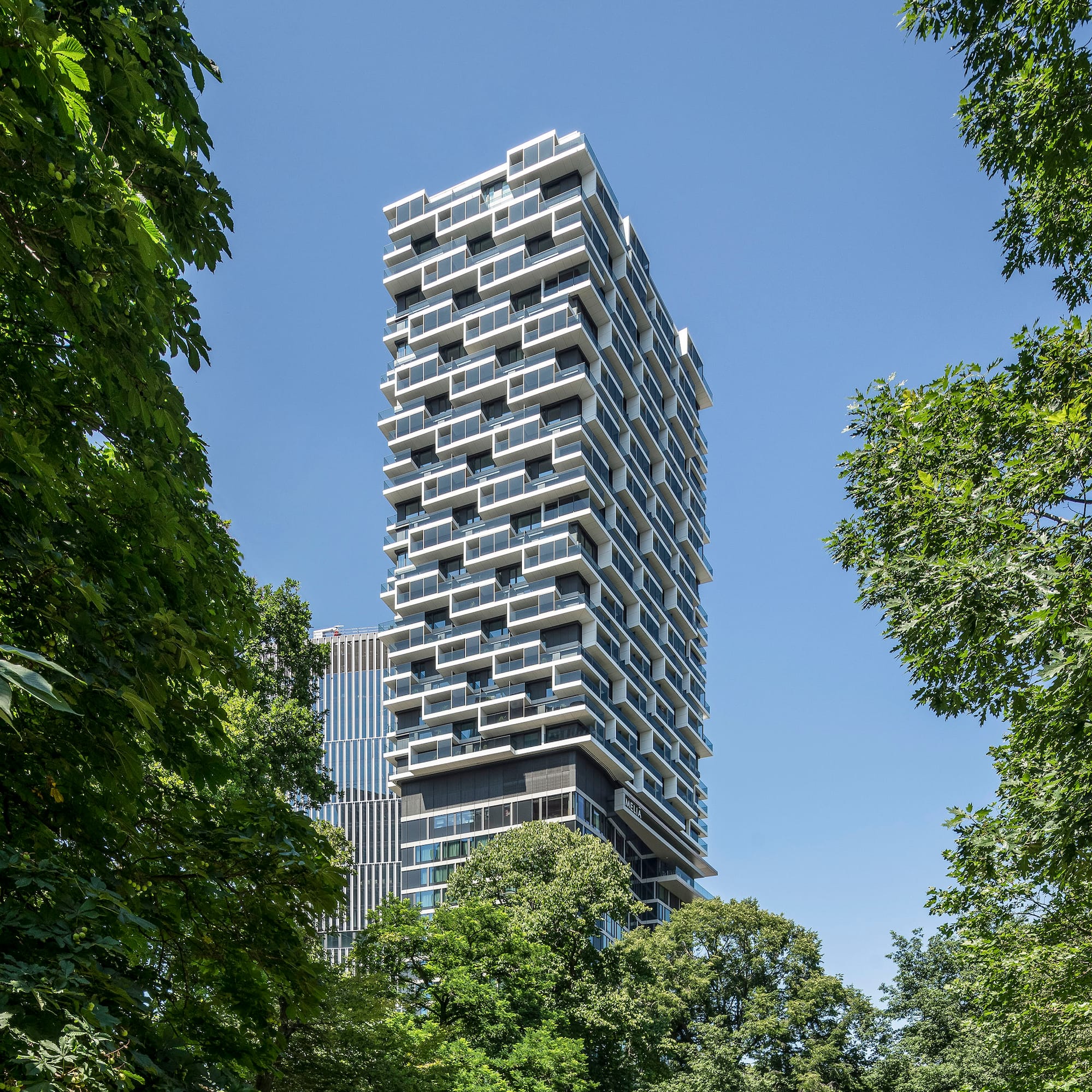 a tall building with trees around it