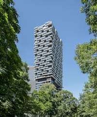a tall building with trees around it